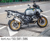 BMW R 1300 GS Adventure motorcycle parked on street. Side view of new motorbike. Редакционное фото, фотограф Константин Григорьев / Фотобанк Лори