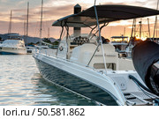 Small motorboat docking at the marina with sunset in Phuket Thailand. Стоковое фото, агентство Ingram Publishing / Фотобанк Лори