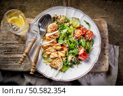 Quinoa and vegetable salad and grilled chicken fillet on white plate, top view. Стоковое фото, агентство Ingram Publishing / Фотобанк Лори