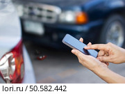 woman using smartphone at roadside after traffic accident, soft focus. Стоковое фото, агентство Ingram Publishing / Фотобанк Лори