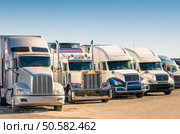 Generic semi Trucks at a parking lot. Стоковое фото, агентство Ingram Publishing / Фотобанк Лори