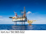 Oil and gas drilling rig work over remote wellhead platform to completion oil and gas produce well by using drilling bit which made from carbide or diamond at head bit and drive by mud pressure. Стоковое фото, агентство Ingram Publishing / Фотобанк Лори