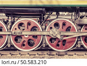 Mechanical part and wheels of the retro steam locomotive.. Mechanical part and wheels of the steam locomotive. Стоковое фото, агентство Ingram Publishing / Фотобанк Лори