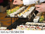 Catering stuff arranging finger food. Стоковое фото, агентство Ingram Publishing / Фотобанк Лори