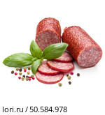 Salami smoked sausage, basil leaves and peppercorns isolated on white background cutout. Стоковое фото, агентство Ingram Publishing / Фотобанк Лори