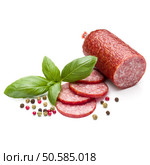 Salami smoked sausage, basil leaves and peppercorns isolated on white background cutout. Стоковое фото, агентство Ingram Publishing / Фотобанк Лори