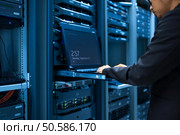 Man fix server network in data center room .. Man fix server network in data center room. Стоковое фото, агентство Ingram Publishing / Фотобанк Лори