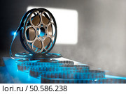 Reel of film on the background screen. Стоковое фото, агентство Ingram Publishing / Фотобанк Лори