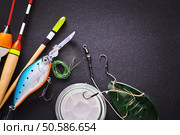 Fishing tackle on dark background. Fishing tackle. Стоковое фото, агентство Ingram Publishing / Фотобанк Лори