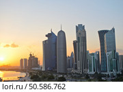 The skyscrapers in the skyline of the commercial center of Doha, the capital of the Arabian Gulf state Qatar at sunset. Стоковое фото, агентство Ingram Publishing / Фотобанк Лори