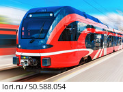 Railroad travel and railway tourism transportation industrial concept: scenic summer view of modern high speed passenger commuter train on tracks at the station platform with motion blur effect. Стоковое фото, агентство Ingram Publishing / Фотобанк Лори