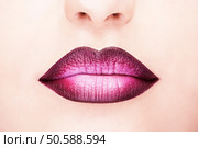 Close-up shot of woman lips with glossy fuchsia lipstick. Стоковое фото, агентство Ingram Publishing / Фотобанк Лори
