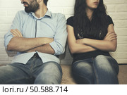 Men and women are offended on brick wall background. Стоковое фото, агентство Ingram Publishing / Фотобанк Лори