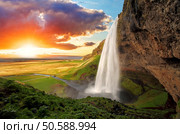 Seljalandsfoss is one of the most beautiful waterfalls on the Iceland. It is located on the South of the island. With a rainbow. Стоковое фото, агентство Ingram Publishing / Фотобанк Лори