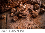 Stack of assorted chocolate bars and pralines. Стоковое фото, агентство Ingram Publishing / Фотобанк Лори