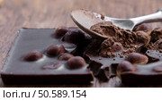 milk chocolate with hazelnuts on a wooden background. Стоковое фото, агентство Ingram Publishing / Фотобанк Лори