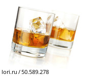Two whiskey glasses. Isolated on white with reflection. Стоковое фото, агентство Ingram Publishing / Фотобанк Лори