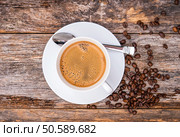 Coffee in White Cup Top View. Reclaimed Wood Table Background. Стоковое фото, агентство Ingram Publishing / Фотобанк Лори