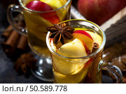 hot apple tea with spices on dark background, top view closeup, horizontal. Стоковое фото, агентство Ingram Publishing / Фотобанк Лори