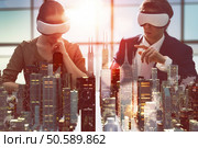 two business persons are developing a project using virtual reality goggles. the concept of technologies of the future. Стоковое фото, агентство Ingram Publishing / Фотобанк Лори