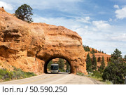 A recreational vehicle RV travels through a tunnel in Red Canyon in Dixie National Forest, Utah. Стоковое фото, агентство Ingram Publishing / Фотобанк Лори