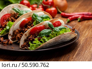 Mexican tacos with minced meat, beans and spices on a plate. Стоковое фото, агентство Ingram Publishing / Фотобанк Лори