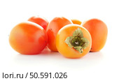 Red ripe persimmons rotating over white background. Стоковое фото, агентство Ingram Publishing / Фотобанк Лори