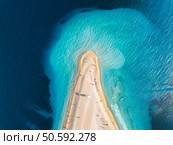 Aerial view of blue sea and amazing Zlatni Rat, Brac island, Croatia in summer. Top drone view of adriatic sea, sandbank with white sandy beach, clear azure water at sunset. Tropical seascape. Travel. Aerial view of blue sea and amazing Zlatni Rat, Brac, Croatia. Стоковое фото, агентство Ingram Publishing / Фотобанк Лори