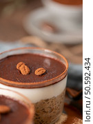 Indulge in a luscious tiramisu-inspired chia pudding, layered with creamy coffee-infused chia and a rich chocolate topping. This delightful breakfast or dessert option combines classic tiramisu flavors with wholesome ingredients for a convenient and satisfying treat. Стоковое фото, агентство Ingram Publishing / Фотобанк Лори