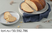 Sweet Portuguese Easter bread Folar elegantly presented on plates with a soft blue napkin and delicate Easter accents evokes a springtime holiday mood. Стоковое фото, агентство Ingram Publishing / Фотобанк Лори