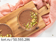 Top view of chocolate mousses with pistachios a sweet dessert food photography shot. Стоковое AI-изображение, агентство Ingram Publishing / Фотобанк Лори