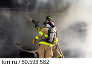 Two firefighters at work putting out a fire. Стоковое фото, агентство Ingram Publishing / Фотобанк Лори
