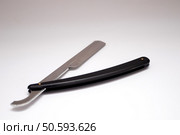 Black straight dangerous razor on a white background. Black straight dangerous razor on a white background. Стоковое фото, агентство Ingram Publishing / Фотобанк Лори
