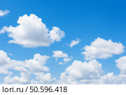 White clouds drifting across vibrant blue sky. Стоковое AI-изображение, AI-художник Иван Рябоконь / Фотобанк Лори