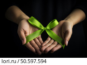 Woman holding green ribbon showing support for mental health awareness. Стоковое AI-изображение, AI-художник Иван Рябоконь / Фотобанк Лори