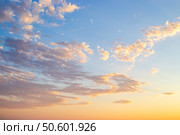 A panoramic photo of the sky with thin cirrus clouds illuminated by the setting sun in soft orange tones. Стоковое фото, фотограф Коханова Наталья / Фотобанк Лори