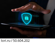 Secure virtual protection displayed on a smartphone screen by a person in a dark environment. Стоковое фото, фотограф Климов Денис / Фотобанк Лори