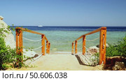 Beautiful entrance to the sea on the steps through a beautiful beach. Стоковое видео, видеограф Igor Skripachev / Фотобанк Лори