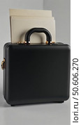 A modern 3D briefcase icon with a matte black finish and gold accents, slightly open to show documents inside, professional aesthetic. Стоковое AI-видео, аниматор Sergey Grishin / Фотобанк Лори