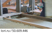 Insulation of a frame house with mineral wool. Cutting, fitting, laying insulation. Construction works. Стоковое видео, видеограф Константин Мерцалов / Фотобанк Лори