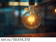 Tungsten filament light bulb shining in blurred background. Стоковое AI-изображение, AI-художник Иван Рябоконь / Фотобанк Лори