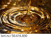 Golden liquid pouring and making concentric ripples on a surface. Стоковое AI-изображение, AI-художник Иван Рябоконь / Фотобанк Лори