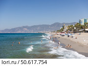 People relax and swim on a beautiful shoreline with clear blue watersю Turkey (2024 год). Редакционное фото, фотограф EugeneSergeev / Фотобанк Лори