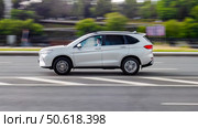 Side view rolling shot with Haval M6 Plus car in motion. Second generation crossover driving along the street in city with blurred background. Редакционное фото, фотограф Константин Григорьев / Фотобанк Лори
