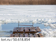 There is an ice hole for walruses to swim in the icy water. Winter baptismal font for the Orthodox feast of the Epiphany. Стоковое фото, фотограф Лазаренко Светлана / Фотобанк Лори