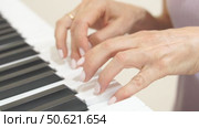 Hands Piano Keys Playing Music: Indoor close-up showing woman's hands playing a keyboard. Стоковое видео, видеограф svetograph / Фотобанк Лори