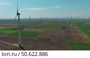 Wind turbines and agriculture fields. Стоковое видео, видеограф Михаил Коханчиков / Фотобанк Лори