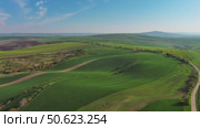 Green wavy hills with agricultural fields (2024 год). Стоковое видео, видеограф Михаил Коханчиков / Фотобанк Лори