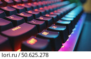 Close up of professional gaming keyboard with colorful LED backlight in multiple colors. Technology in gaming or developer industry. Desktop computer accessories. Стоковое AI-видео, аниматор Sergey Grishin / Фотобанк Лори