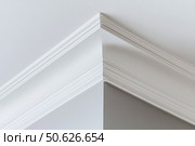 Ceiling close-up. Classic interior. LED Retrofit Bulb into Ceiling Fixture. Cornice. Installing. Decorative Ceiling crown molding intersection. Wall Corner Architecture Decor. Angular ceiling skirting. Стоковое AI-изображение, AI-художник Марина Демидюк / Фотобанк Лори